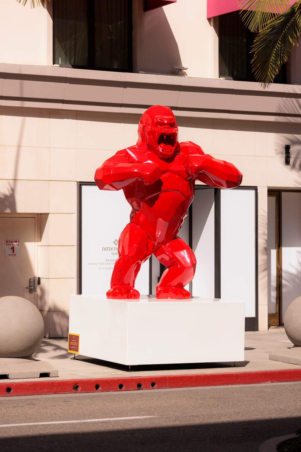 Richard Orlinski's red Wild Kong sculpture on a city sidewalk